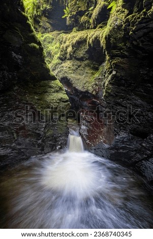 Long exposure of the Devils Cauldron waterfall on the river Lyd at Lyford Gorge in Devon