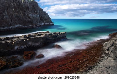 Long Exposure of a Dramatic Pristine Blue Ocean Coastline With a Large Cliff on a Sunny Day, Devils Kitchen, Noosa National Park, Noosa Heads, Sunshine Coast, Queensland, Australia