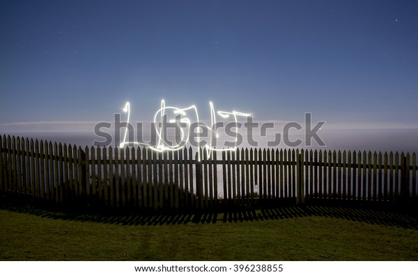 Long exposure of fence at night with Light\
subtitle, made by Light\
painting