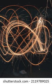 Long Exposure Of A Girl Playing With Sparklers Creating A Light Drawing