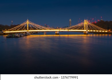 Long exposure, illuminated Albert bridge over river Thames in London