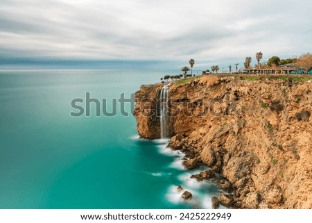 Long exposure image of the waterfall falling from the cliffs into the sea in Fener, Antalya