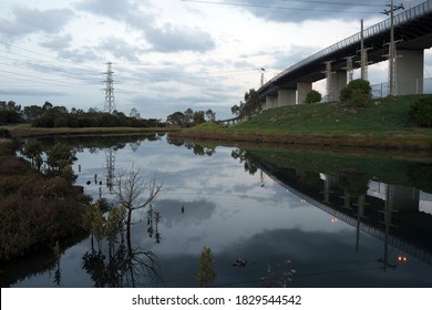 Long Exposure Image Of The West Gate Bridge At Twilight, On Its Way Into Melbourne From The Industrial Western Suburbs, With Stony Creek In The Foreground.