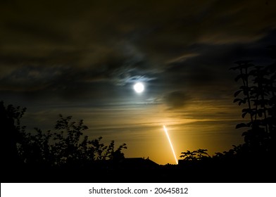 Long exposure of the last night launch of space shuttle Endeavor mission STS-126 from Cape Canaveral on November 14th 2008 with moon partially covered by clouds - Powered by Shutterstock