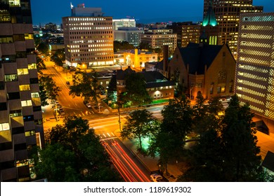 Long Exposure Light Trails Cars Driving Around Downtown Denver , Colorado Streets And City Night Life Alive And Illuminating The Night In The Mile High City