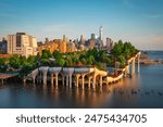 Long exposure of Little Island over the Hudson River in Chelsea, New York, with the lower Manhattan skyline as a stunning backdrop at dusk.
