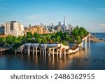 Long exposure of Little Island over the Hudson River in Chelsea, New York, with the lower Manhattan skyline as a stunning backdrop at dusk.