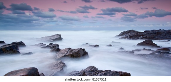 Long Exposure Of Misty Sea And Rocks