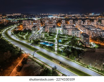 Long exposure of modern blocks of flats at night with traffic trails and lights - modern Krakow cityscape
