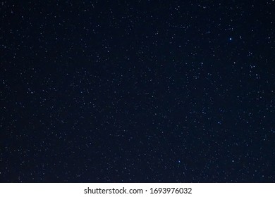 Long exposure night photo of a bright stars. A lot of stars with constellations. Far from the city. Night landscape. - Shutterstock ID 1693976032