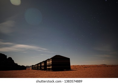 Long Exposure Night Photography Of Bedouin Tent Camp In Wadi Rum Desert In Jordan