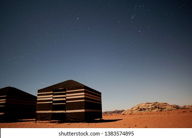 Long Exposure Night Photography Of Bedouin Tent Camp In Wadi Rum Desert In Jordan