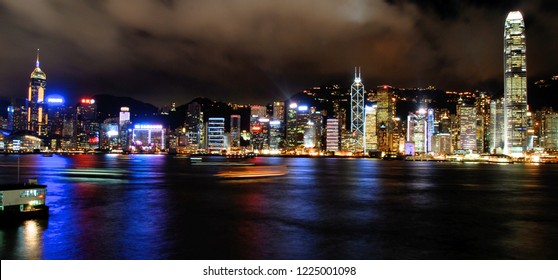 Long Exposure Night Shot Of Hong Kong Victoria Harbour With Light On Buildings In Central
