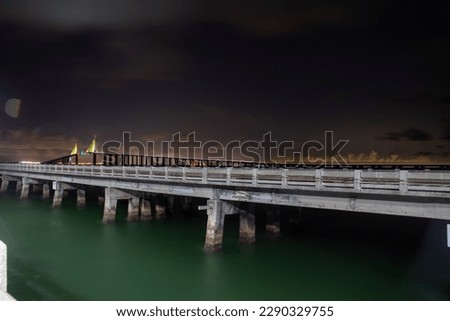 Long exposure night time photos of the Tampa Bay Sunshine Skyway Bridge lights from the fishing pier.