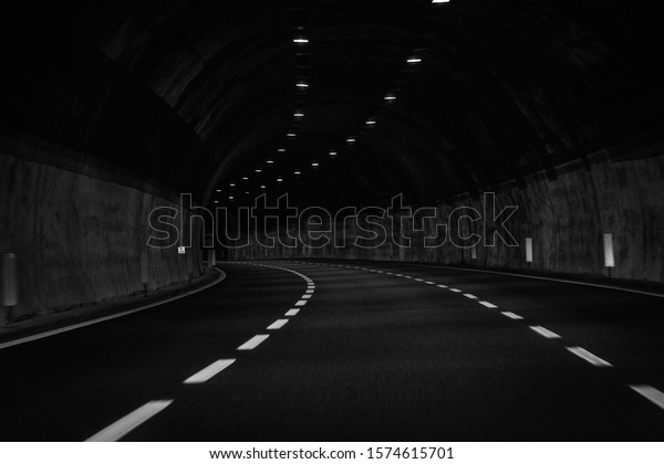 Long exposure\
photo of car tunnels in\
motion