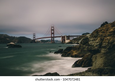 Long Exposure photo of Foggy Golden Gate Bridge in San Francisco, CA, from the rocky Baker beach - Powered by Shutterstock