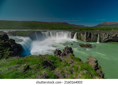 Long exposure photo of magnificent Godafoss waterfall in northern Iceland on a warm summer day. Visible frog from drops of water coming from the waterfall.