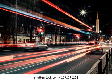 Long exposure photo at night. Light trails on the road. City street.