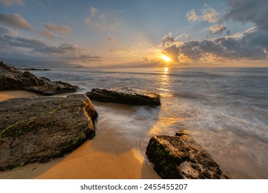 Long exposure photo of waves and rocks at sunrise. - Powered by Shutterstock