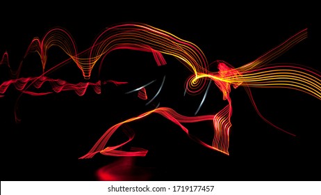 Long exposure photograph of neon colours (red and yellow) in an abstract lines against a black background. It seems infinity. Light painting photography. Good wallpaper. Multicolored dynamic