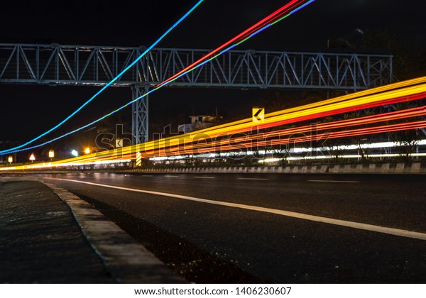 Long exposure photographs of\
night traffic of Indian national highway. A view from Kerala,\
India