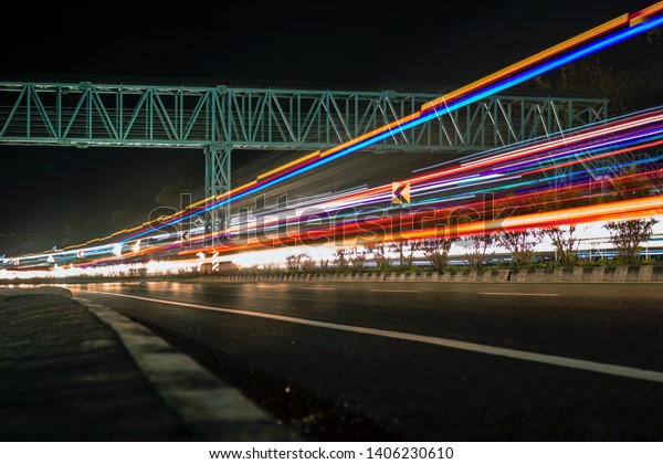 Long exposure photographs of\
night traffic of Indian national highway. A view from Kerala,\
India