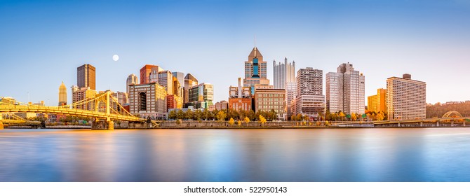 Long exposure of Pittsburgh downtown skyline and Roberto Clemente bridge, on a sunny afternoon, as viewed from North Shore Riverfront Park, across Allegheny River.