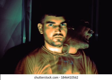 Long Exposure Portrait Of A Young Man In A Dark Room With Motion Blur And Ghost Effect