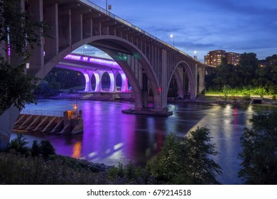 A Long Exposure Of The Purple 35W Bridge And Neighboring Tenth Ave Bridge Over The Mighty Mississippi River At Twilight