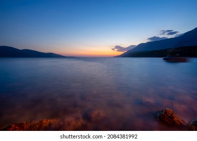 Long exposure of the sea at blue hour over a rocky beach. Sunset view of Gulf of Gokova (Akyaka). Gulf of Gokova is a long narrow gulf of the Aegean Sea in southwest Turkey.