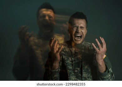 Long exposure of serviceman in uniform screaming while suffering from dissociation disorder isolated on dark grey - Powered by Shutterstock