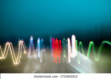 Long exposure shot from a car on a highway - abstract  light painting multi color zig zag wave like pulse line 