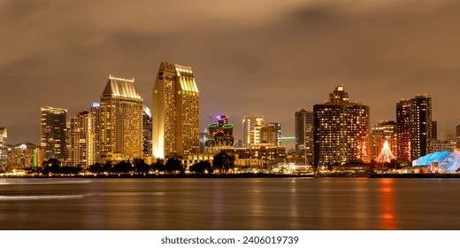 Long exposure shot of downtown San Diego, California, USA skyline and San Diego Bay with reflections on a cloudy winter night taken on December 25, 2023 from Centennial Park in Coronado Island. - Powered by Shutterstock