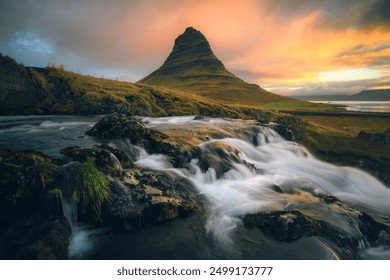 Long exposure shot of the Kirkjufell mountain with the river in the foreground, in Iceland, sunrsie, epic view - Powered by Shutterstock