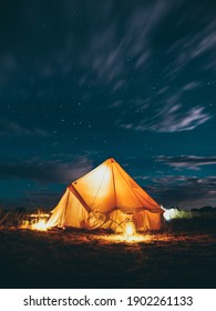 Long Exposure Shot Of Light Up Yurt At Night With Stars In The Sky