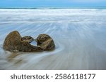 Long exposure shot of Moeraki Boulders in New Zealand. Famous landmark large spherical stones on Koekohe Beach near Moeraki on New Zealand