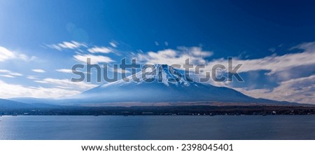 Long exposure shot of Mt. Fuji with snow cap and Lake Yamanakako at daytime.
