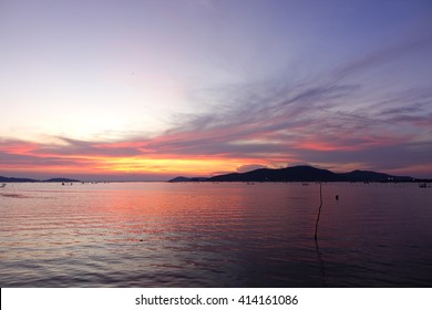 Long Exposure Shot Over The Silhouette Image Of Island,the Long Concrete Bridge,the Lake And Downtown At Songkhla Thailand During Sunset.Motion Blur, Soft Focus Due To Slow Shutter Speed.