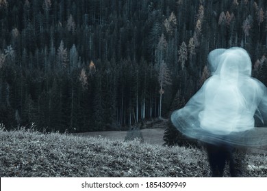 Long Exposure Shot Of Subject In Movement, Creating A Ghost Or Spirit Or Ectoplasm Appearing Just Outside A Thick Forest.