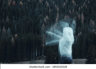 Long Exposure Shot Of Subject In Movement, Creating A Ghost Or Spirit Or Ectoplasm Appearing Just Outside A Thick Forest.