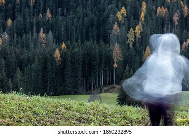 Long Exposure Shot Of Subject With White Hoodie N Movement, Creating A Ghost Or Spirit Or Ectoplasm Appearance Just Outside A Thick Forest.