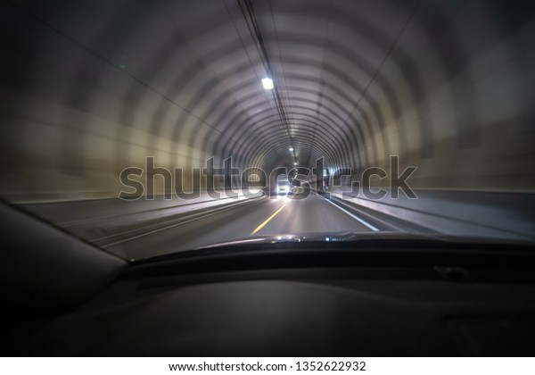 Long exposure\
shot of tunnel at Lofoten from inside a car that is moving so the\
light creates tunnel vision\
effect