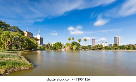 Long exposure of the skyline of Nairobi, Kenya with the beautiful lake in Uhuru Park in the foreground and some blurred boats.