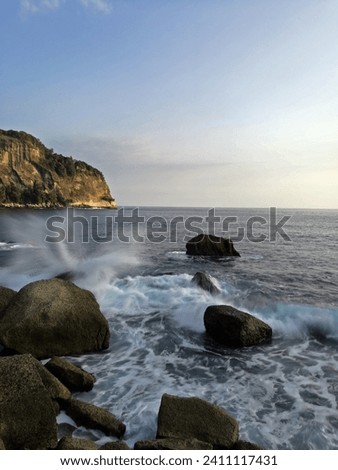 Long exposure of splashing waves on a rocky beach in Pacitan, East Java, Indonesia