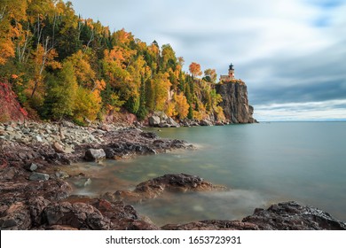 Long Exposure Of Split Rock Lighthouse Complemented With Fall Colored Trees And Lake Superior