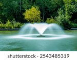 Long exposure of spouting fountain in the "The Garden of Gaston" Arboretum during summer 2024