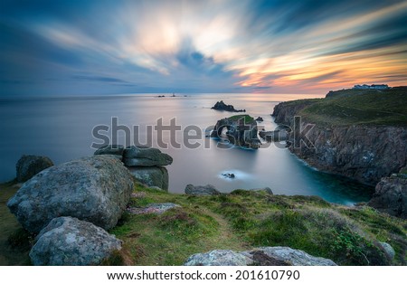 A long exposure of a sunset over Lands End in Cornwall, looking out towards the Long Ships lighthouse