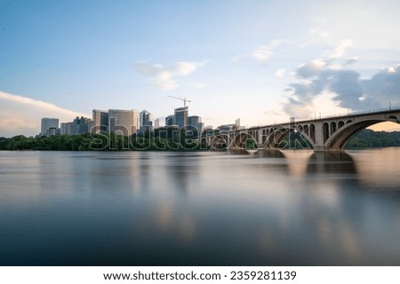 A long exposure sunset photo of the Rosslyn Virginia skyline and the Francis Scott Key Memorial Bridge.