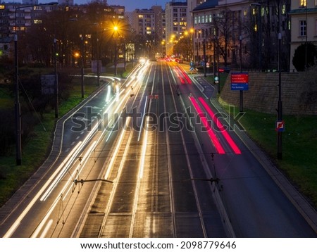 long exposure time, street in the evening seen from above, long lights of cars and trams, light drawing Warsaw December 2020