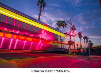 Long exposure of train with moody sky and palm trees in San Clemente, California 